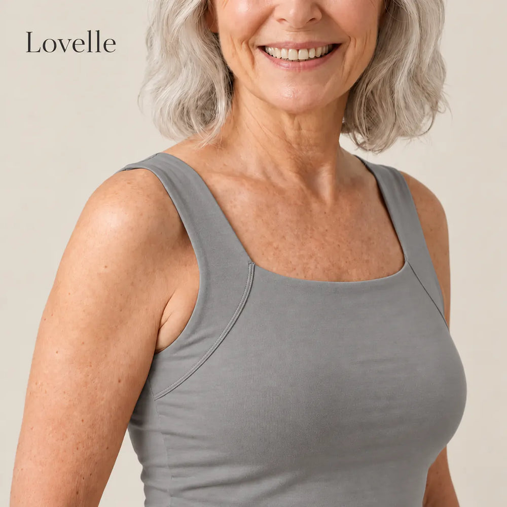 Smiling silver-haired woman wearing the Lovelle Ease built-in bra tank in grey, square neckline and wide straps