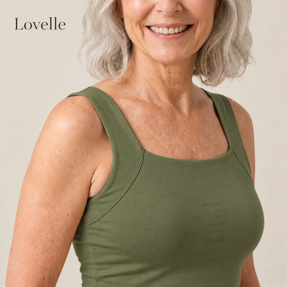 Smiling silver-haired woman wearing the Lovelle Ease built-in bra tank in olive green, square neckline and wide straps