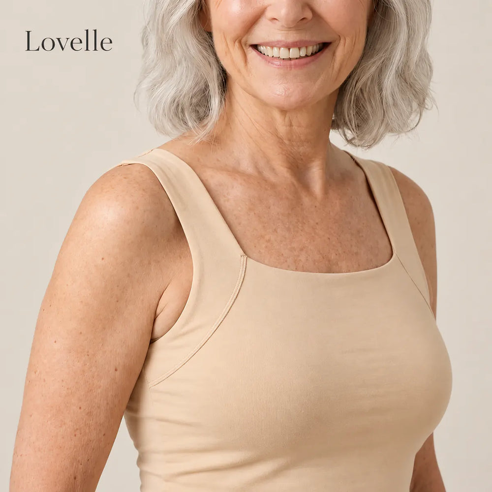 Smiling silver-haired woman wearing the Lovelle Ease built-in bra tank in nude, square neckline and wide straps